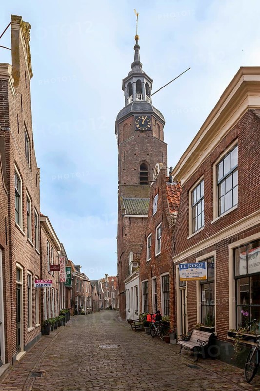 Alley with traditional houses and church in the town of Blokzijl, province of Overijssel, Netherlands