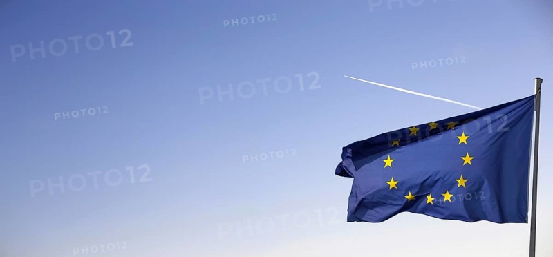 Flag of the European Union in front of a blue sky (Flag of the European Union in front of a blue blue sky)