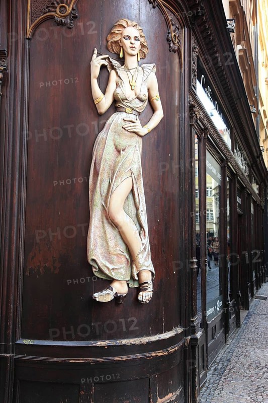 Scantily clad young woman as a facade decoration on a shop in Karlsgasse, Old Town, Prague, Czech Republic, Europe