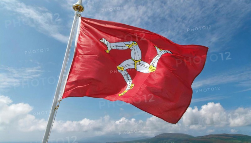 The flag of the Isle of Man, Great Britain, flutters in the wind
