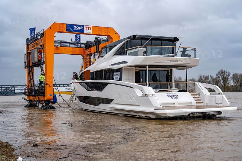 Craning the €6.3 million Sunseeker 88Y motor yacht, weighing 82 tonnes, in preparation for the world's largest water sports trade fair, Boot in Düsseldorf, luxury yachts are driven across the Rhine to the trade fair and brought ashore with the help of the Big Willi ship crane and transported to the exhibition halls on a low-loader, North Rhine-Westphalia, Germany, Europe