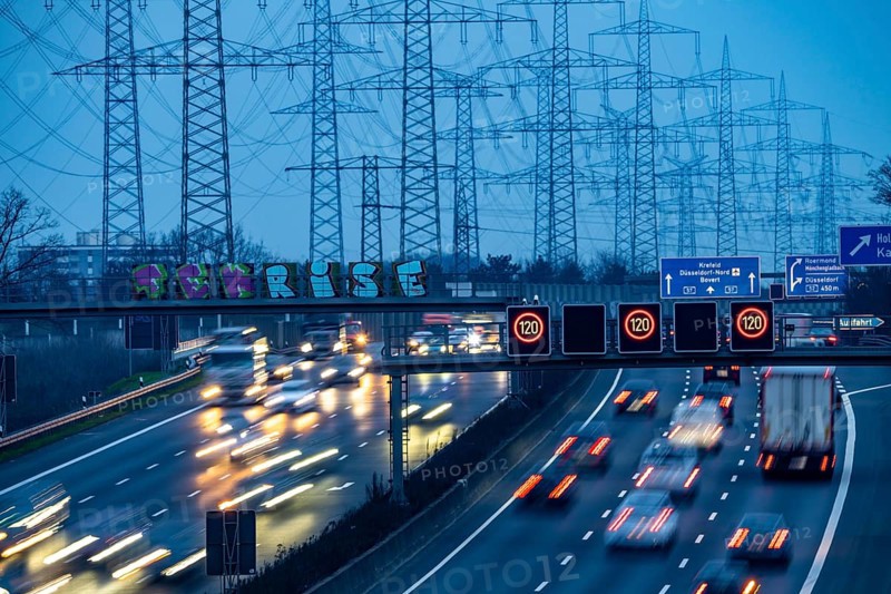 A57 motorway near Kaarst in the Rhine district of Neuss, view in the direction of the Kaarst motorway junction, heavy evening traffic, overhead power lines, along the motorway, North Rhine-Westphalia, Germany, Europe