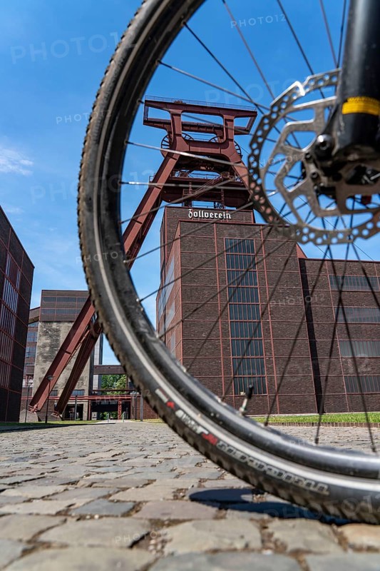 Cycling in the Ruhr region, by bike, e-bike, at the Zollverein Coal Mine Industrial Complex World Heritage Site, double trestle winding tower shaft XII, Essen, North Rhine-Westphalia, Germany, Europe