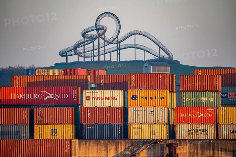 Container Handling Centre, Gateway West Terminal, Logport 2, cargo ship, in Duisburg on the Rhine, in the background Tiger and Turtle - Magic Mountain is a landmark modelled on a roller coaster on Heinrich-Hildebrand-Höhe in Angerpark in Duisburg-Angerhausen, North Rhine-Westphalia, Germany, Europe