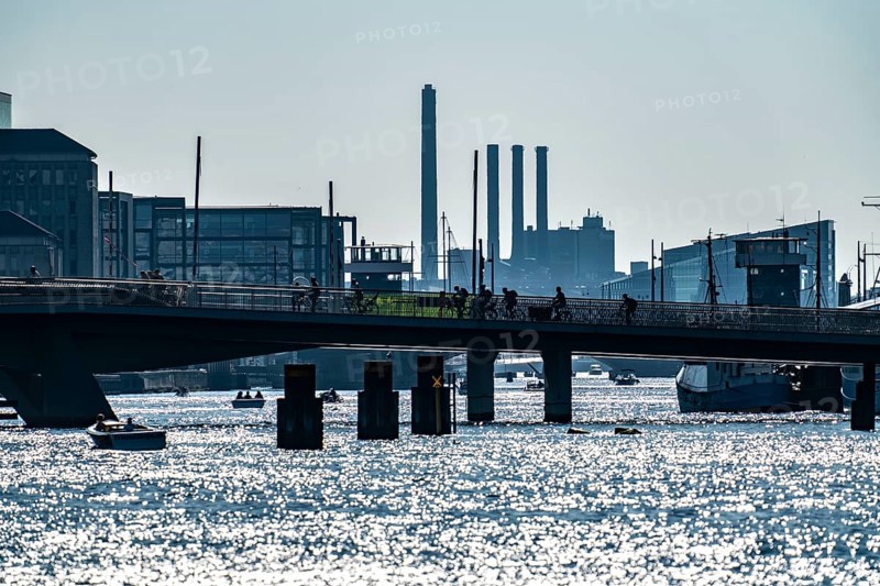 View over the harbour, the pedestrian and cycle bridge Inderhavnsbroen, skyline at Sydhavnen in the background, chimneys of the combined heat and power plant H.C. Ørstedsværket, Copenhagen, Denmark, Europe