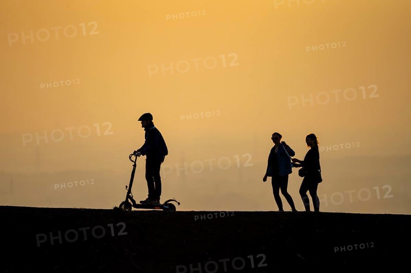 The Haniel spoil tip, 185 metres high, at the Prosper Haniel mine, closed in 2019, people on the way to the spoil tip, behind the decommissioned Voerde coal-fired power station, Bottrop, Germany, Europe