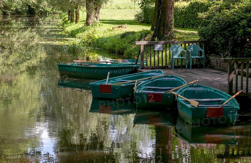 Green boats on the wooden jetty, Alstätter Aa near the Haarmühle, Ahaus-Alstätte, Münsterland, North Rhine-Westphalia, Germany, Europe