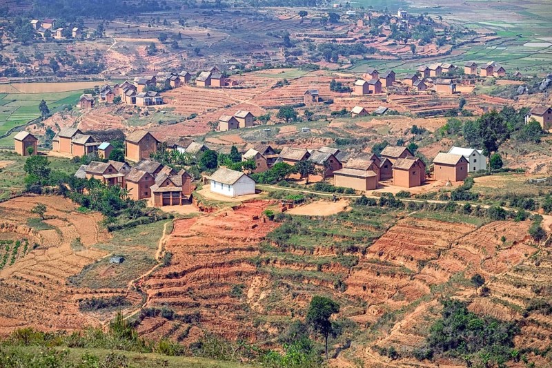 Terraced fields and two stories brick houses in Betsileo rural village in the Ambositra District, Amoron'i Mania Region, Central Madagascar