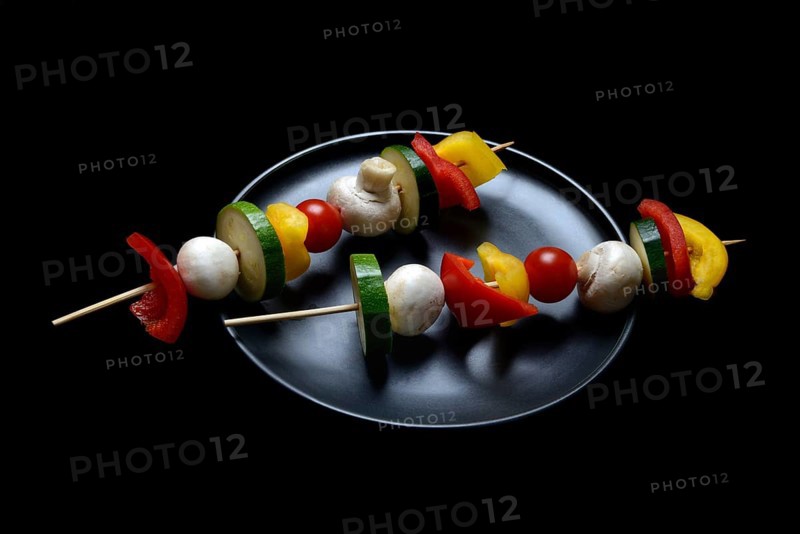 Colourful vegetable skewers on a plate, barbecue skewers