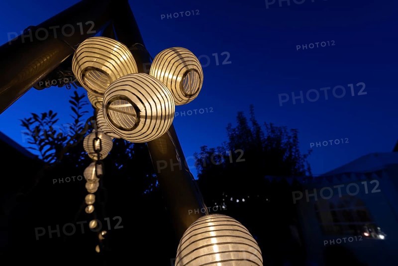 Lanterns, paper lanterns, fairy lights in a garden, blue hour, Germany, Europe