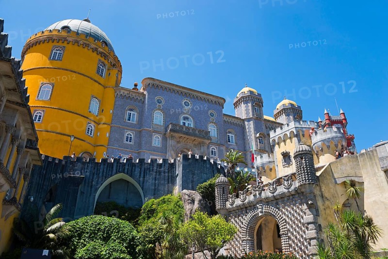 Castle with grey and yellow towers against a blue sky, surrounded by plants, Palácio Nacional da Pena, Pena National Palace, Sintra, Lisbon, World Heritage Site, UNESCO, Portugal, Europe