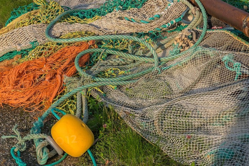 Fishing nets, ropes and floats lying in a meadow, Greetsiel, Krummhörn, East Frisia, Lower Saxony, Germany, Europe