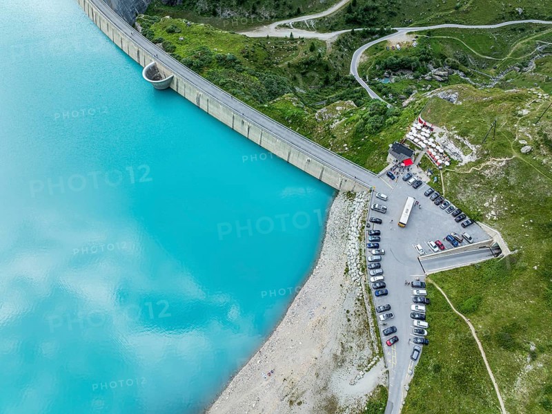 Dam of the Moiry lake, Lac de Moiry, turquoise glacial water, parking lot and restaurant at the dam, aerial view, Valais, Switzerland, Europe