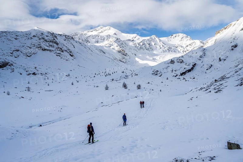 Ski tourers ascending in the rear Martell Valley, snow-covered mountain peak Monte Cevedale behind, Ortler Alps, Vinschgau Valley, Italy, Europe