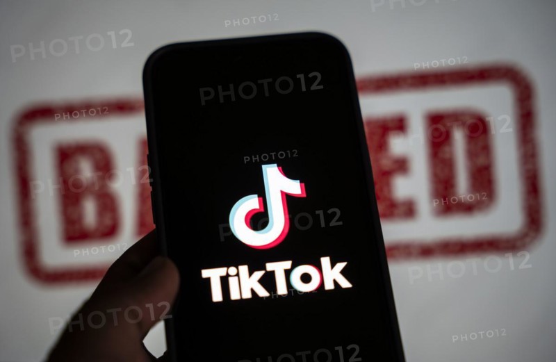 In this photo illustration, logo of Tiktok is displayed on mobile phone screen next to ban sign, in Guwahati, India 25 April 2024. US President Joe Biden signs law to ban Chinese-owned TikTok unless sold to US company