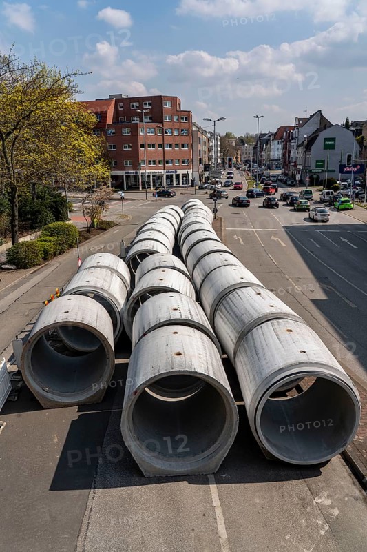 Concrete sewer pipes, stored on a construction site during sewer renovation work, on the Dickswall, city centre of Mülheim an der Ruhr, North Rhine-Westphalia, Germany, Europe