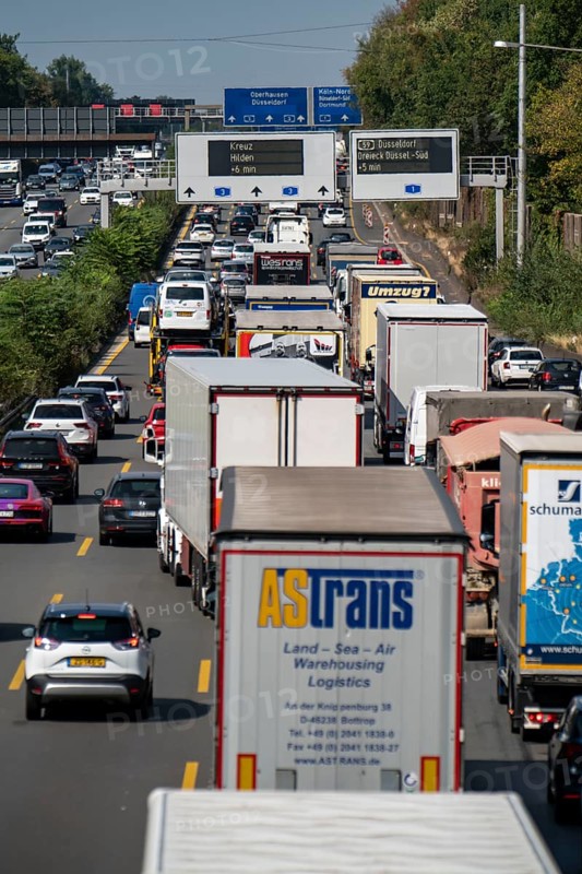 Traffic jam on the A3 motorway, over 8 lanes, in both directions, in front of the Leverkusen motorway junction, Friday afternoon high traffic volume, roadworks, gantry signs with journey times, delays due to the traffic jam, Leverkusen, North Rhine-Westphalia, Germany, Europe
