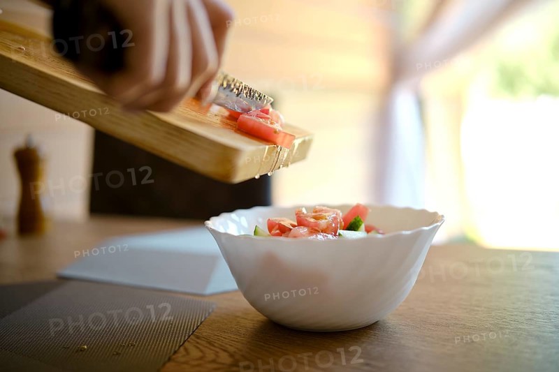 Close-up view of making juicy fresh organic vegetable salad