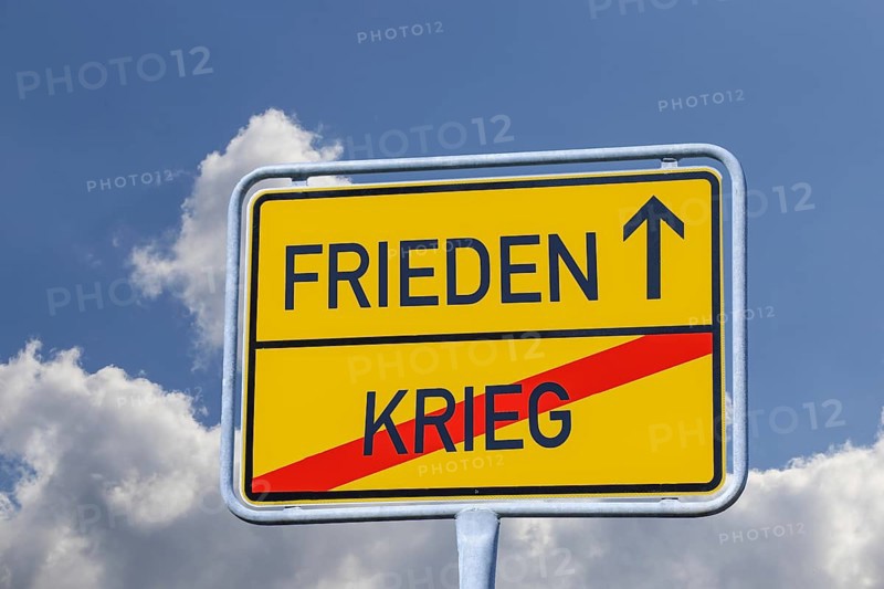 Symbolic image of war/peace: According to a town exit sign, you are leaving war and travelling towards peace (Composing)