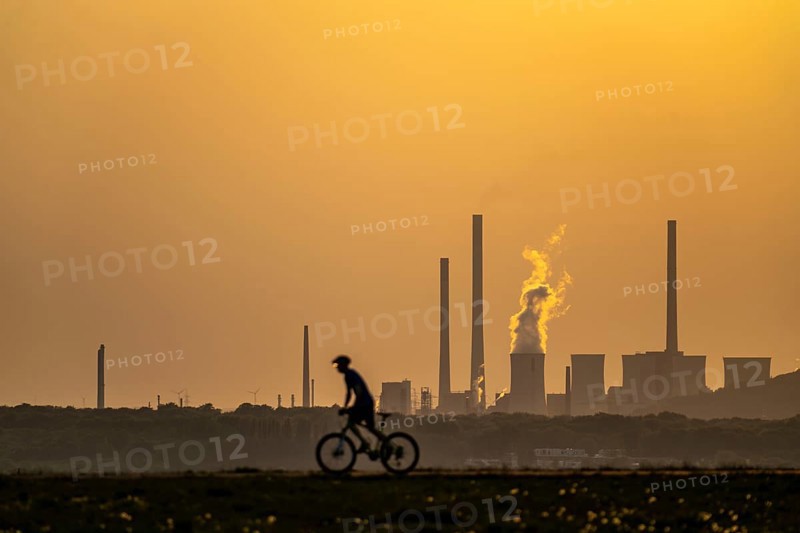 Evening atmosphere on the Hoheward spoil tip, the largest spoil tip in the Ruhr area, between Herten and Recklinghausen, with the Scholven power station in Gelsenkirchen, North Rhine-Westphalia, Germany in the background
