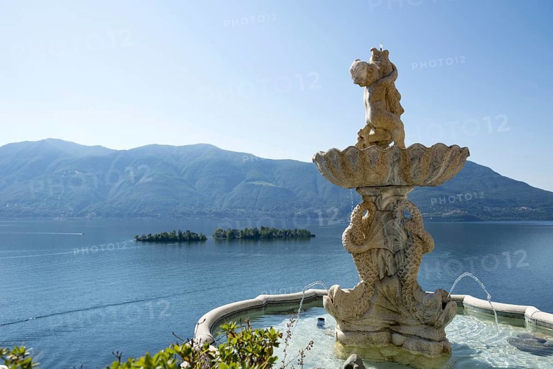Fountain Statue with View Over Lake Maggiore with Brissago Islands and Mountain in a Sunny Day in Ronco sopra Ascona, Ticino, Switzerland, Europe