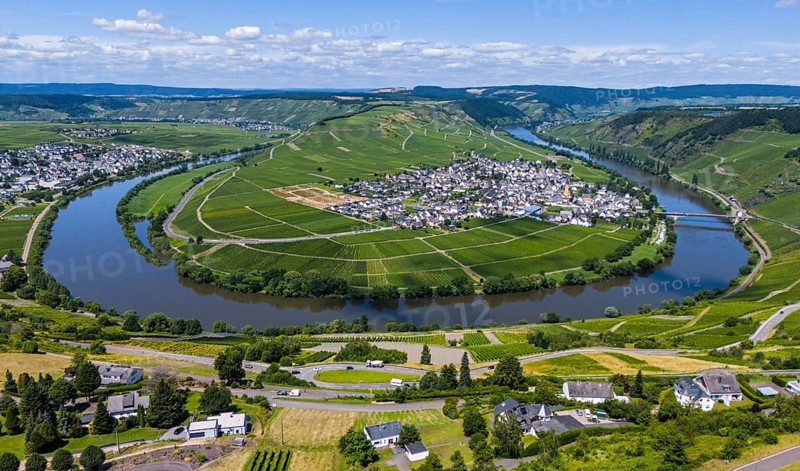 Aerial view of a village, surrounded by a river in the middle of vineyards and fields on a wide hilly landscape, aerial view, Moselle, Moselle loop, Leiwen, view of Trittenheim, Trier-Saarburg, Rhineland-Palatinate, Germany, Europe
