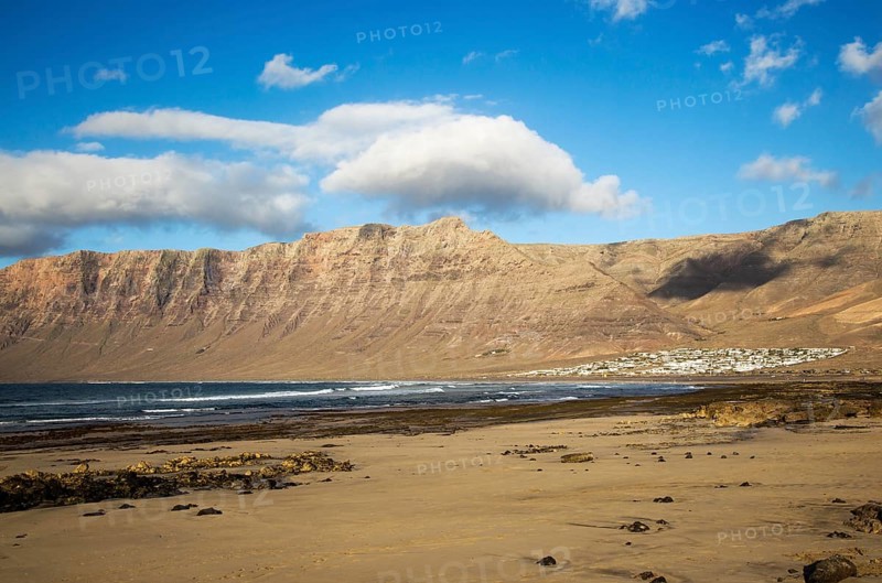 Late afternoon light on beach and cliffs La Caleta de Famara, Lanzarote, Canary islands, Spain, Europe