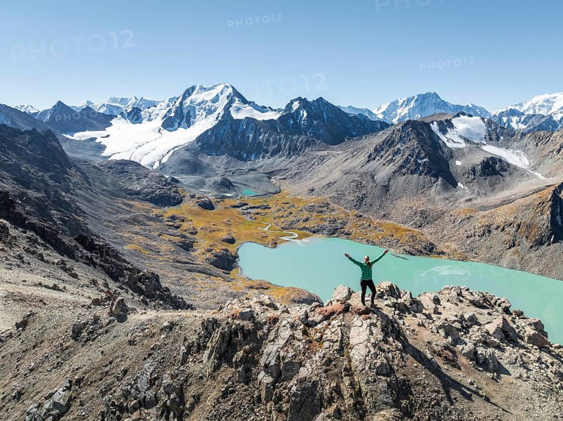 Hiker at the pass at 4000m, aerial view, mountains with glacier, mountain pass and mountain lake Ala-Kul Lake, Tien Shan, Kyrgyzstan, Asia