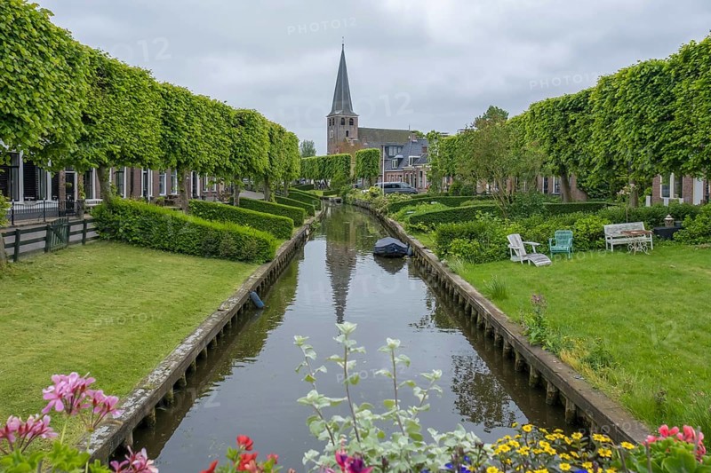 Church and river Ee with the bleaching meadows, Ijlst, province of Friesland, Netherlands