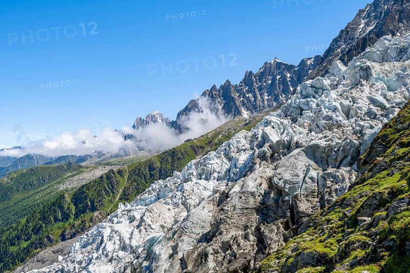 Glacier ice of the Glacier des Bossons, behind pointed mountain peaks, Chamonix, Haute-Savoie, France, Europe