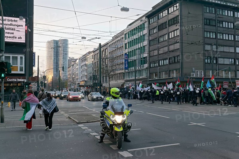 Demonstration procession on Berliner Allee, traffic policeman on motorbike, Pro Palestine demonstration on 2 December 2023 in Düsseldorf, North Rhine-Westphalia, Germany, Europe