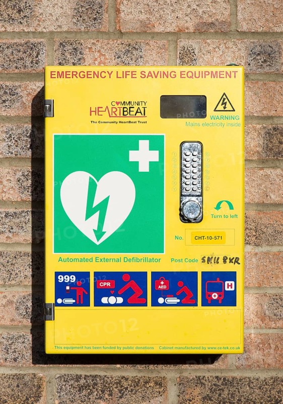 Automated External Defibrillator emergency life saving equipment mounted on wall, Community Heartbeat, Wiltshire, England, UK