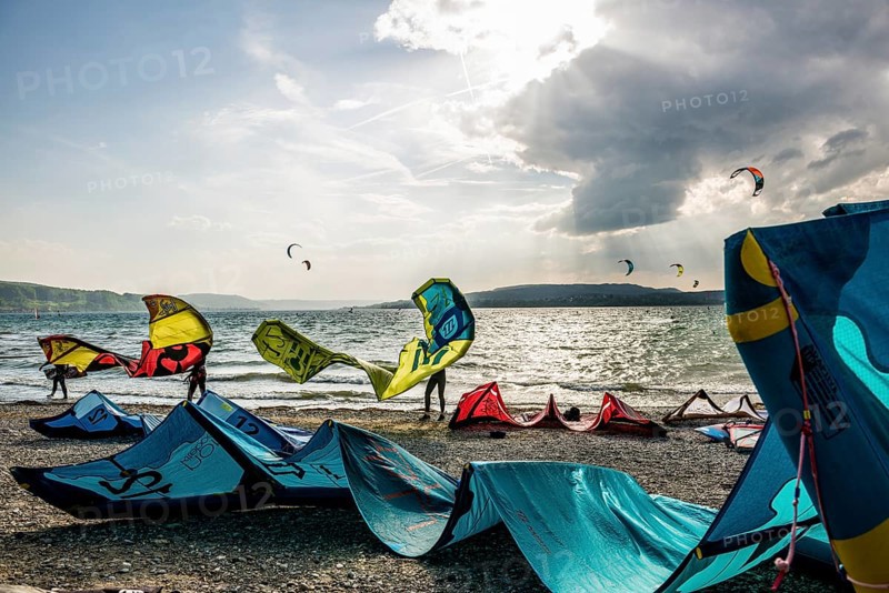 Kitesurfers and windsurfers in sun and storm, Reichenau Island, Untersee, Lake Constance, Baden-Württemberg, Germany, Europe