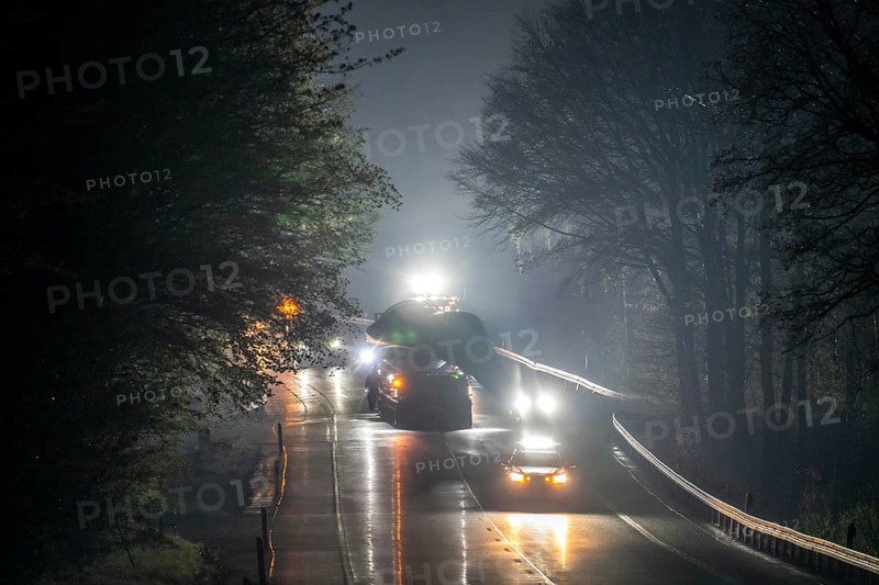 Transport of a 68 metre long, 22 tonne blade of a wind turbine with a self-propelled Blade-Lifter vehicle, over a 40 km long route, over 2 nights, in the Bergisches Land, through towns, villages, on country roads, narrow through roads, to the construction site of the wind turbine near Hagen, North Rhine-Westphalia, Germany, Europe