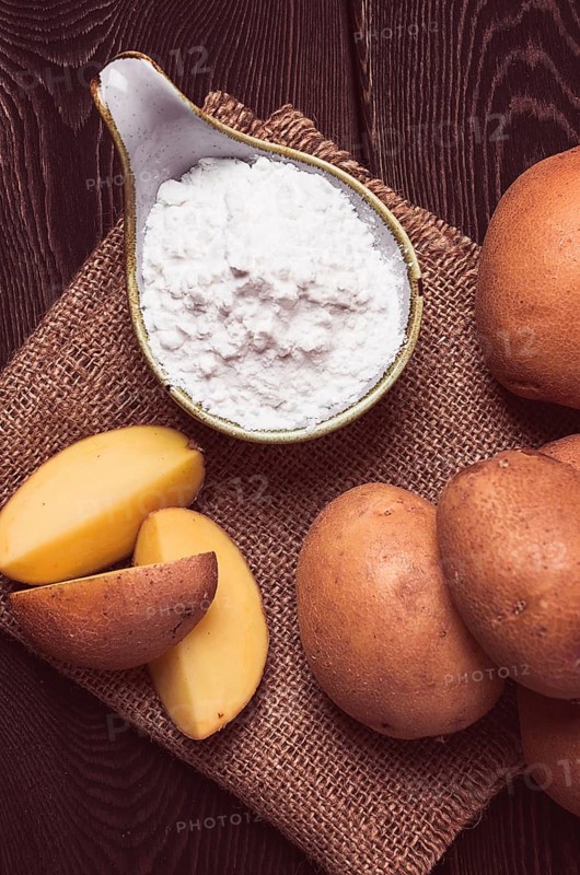 Potato starch, on a wooden table, close-up, rustic style, no people, potatoes, ceramic spoon, saucepan, wooden table, brown