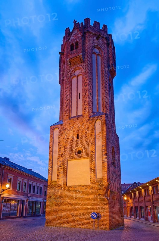 The brick Gothic Owl Tower, illuminated at night, in the old town centre of Tangermünde, Hanseatic town in the Altmark. Saxony-Anhalt, Germany, Europe