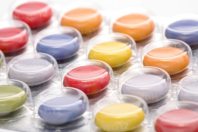 Colourful tablets packed in plastic, tablet addiction, drug addiction, studio