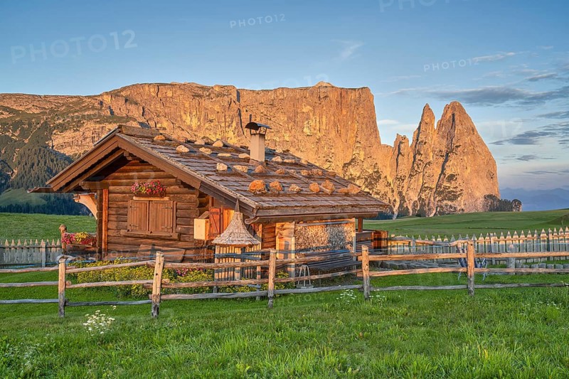 Alpine hut in front of Schlern, sunrise, blue sky, Seiser Alm, Dolomites, South Tyrol
