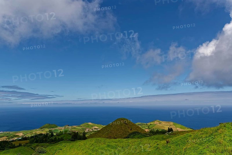 Sweeping views over green volcanic hills that gently fade into the sea under a big sky, Caldeira das Sete Cidades, Sete Cidades, Sao Miguel Island, Azores, Portugal, Europe