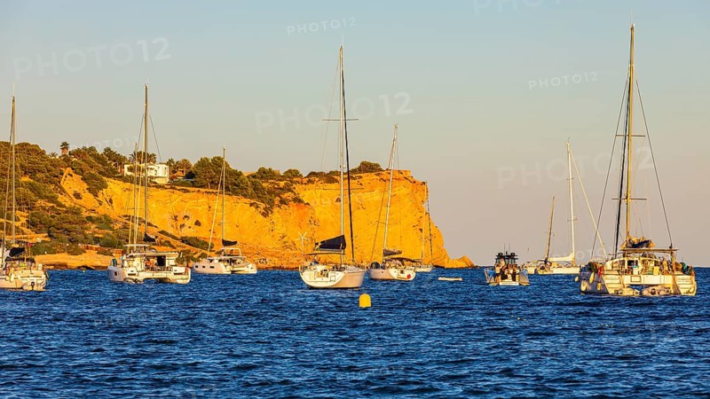Sailing yachts in the bay of Talamanca, behind the rock Punta de s'Andreus, Eivissa, Ibiza Town, Ibiza, Balearic Islands, Mediterranean Sea, Spain, Europe