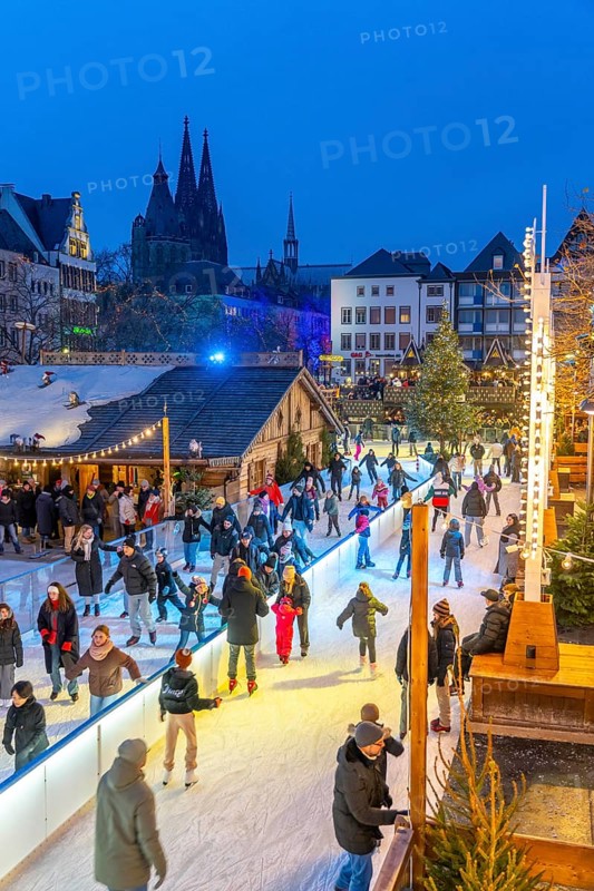 Ice rink at the Christmas market on the Heumarkt in the old town of Cologne, Cologne Cathedral, Sunday shopping in Cologne city centre, 1st Advent weekend, North Rhine-Westphalia, Germany, Europe