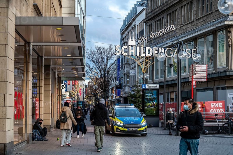 First day of the Christmas lockdown in the Corona crisis, empty shopping alleyway Schildergasse, closed shops, police patrol, hardly any passers-by, in Cologne, North Rhine-Westphalia, Germany, Europe