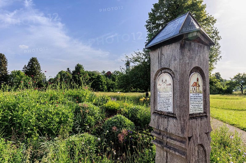 Old wooden information board in front of Schlehdorf Monastery, Schlehdorf, spring, sunny, Bavaria, Germany, Europe