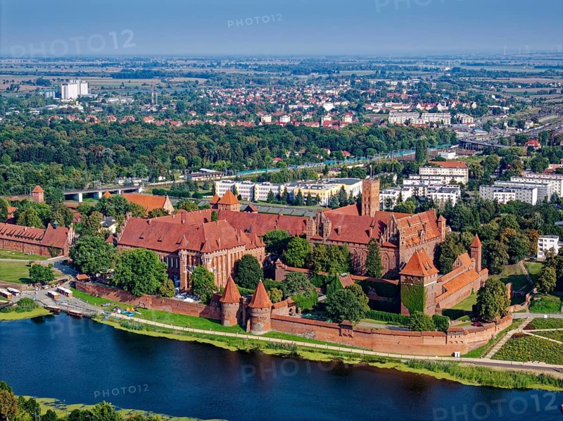 Aerial view of the monastery and the town of Marienburg. The Ordensburg, the former seat of the Teutonic Order in the town of Marienburg in northern Poland, is built in the brick Gothic style. The castle is located on the River Nogat. It is a UNESCO World Heritage Site. Malbork, Pomerania, Poland, Europe