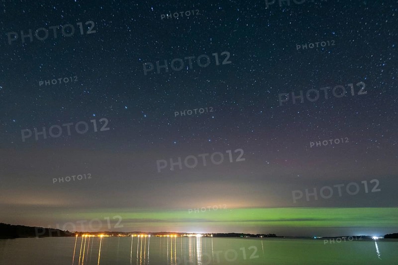 Northern lights (aurora borealis) shine on a starry night over Lake Plau, Ganzlin, Mecklenburg-Vorpommern, Germany, Europe