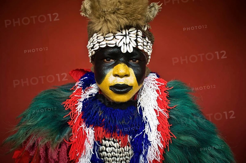 Portrait of a Zimba performer Gambia . Zimba dancers dress like a lion. While performing, they imitate the behaviour of a lion, symbol of power, courage and loyalty