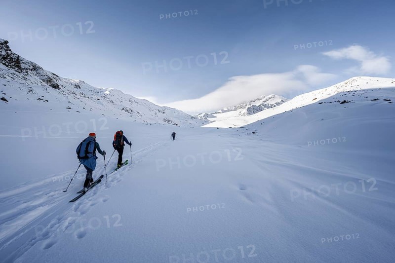 Two ski tourers ascending in fresh snow, snow-covered mountain peak Monte Cevedale in the background, wintry mountain landscape, Ortler Alps, Vinschgau Valley, Italy, Europe