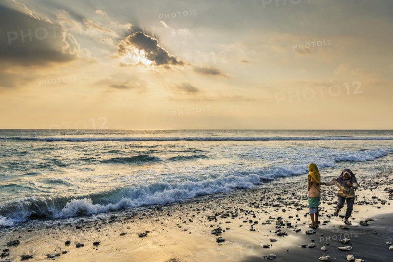 Muslim woman in the evening sun at Mangsit beach in Sengiggi, Islam, religion, headscarf, travel, tourism, sea, beach, water, respect, dramatic, drama, emotion, play, joy, surf, surf, ocean, island, coast, tropical, tropics, Asian, natural landscape, untouched, tourism, holiday, lonely, deserted, calm, authentic, authenticity, original, atmosphere, holiday mood, long-distance travel, tradition, traditional, poverty, culture, tradition, holiday idyll, Lombok, Indonesia, Asia