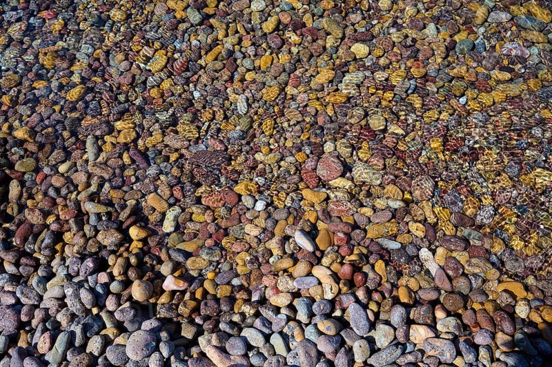 Colourful pebbles in the water with different textures and patterns, Lambi beach, pebble beach, Patmos, Dodecanese, Greek Islands, Greece, Europe