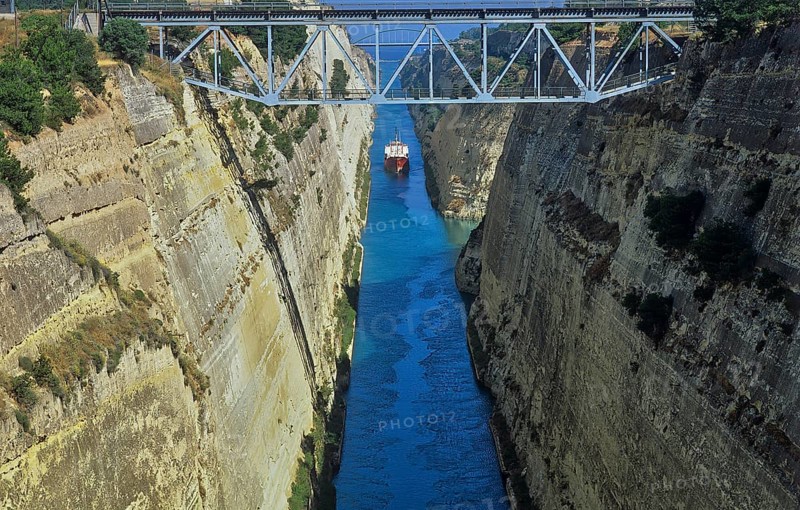 View of a ship navigating through a narrow channel with steep, rocky walls, Corinth Canal, Corinth, Peloponnese, Greece, Europe